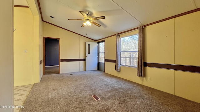 spare room featuring ceiling fan, lofted ceiling, and light carpet