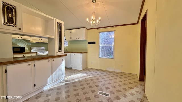 kitchen featuring vaulted ceiling, an inviting chandelier, white electric stove, white cabinetry, and hanging light fixtures