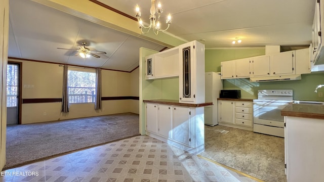 kitchen with plenty of natural light, white cabinetry, white appliances, and vaulted ceiling