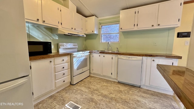 kitchen featuring white appliances, white cabinetry, and sink