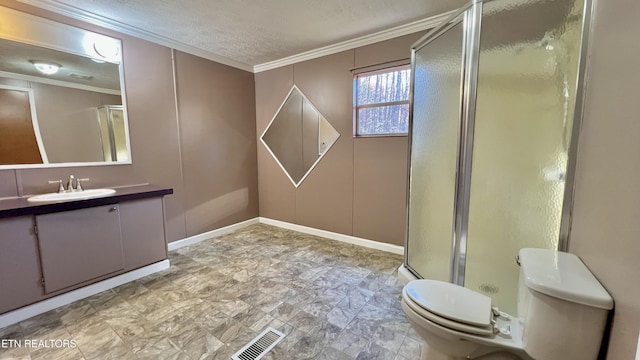 bathroom with a textured ceiling, toilet, vanity, a shower with shower door, and ornamental molding