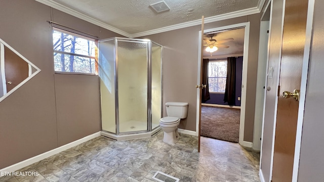 bathroom featuring a healthy amount of sunlight, toilet, a textured ceiling, and walk in shower