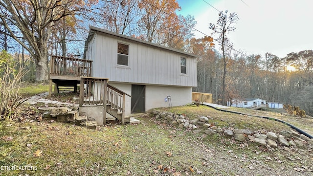 view of side of home featuring a wooden deck