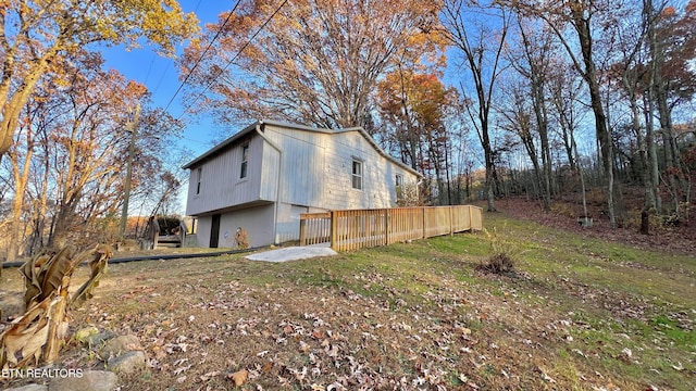 view of side of property featuring a wooden deck