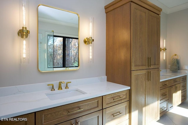 bathroom featuring tile patterned flooring, vanity, and ornamental molding