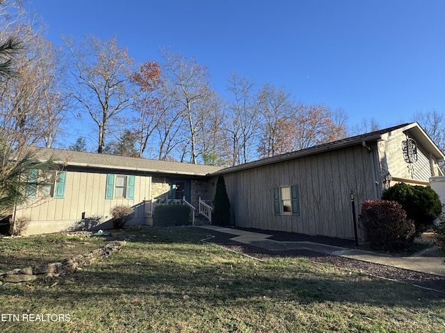 view of side of home featuring a yard