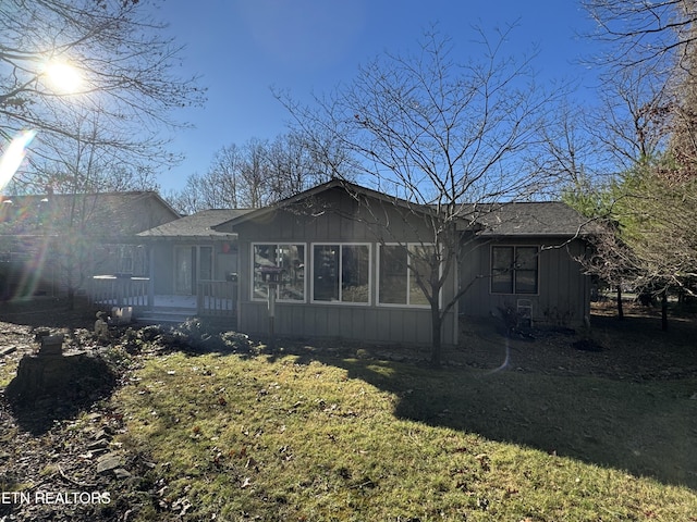 view of side of home with a lawn