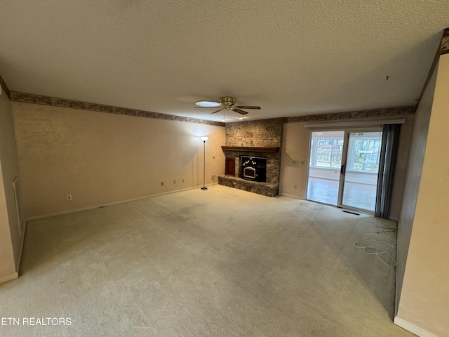 unfurnished living room with ceiling fan, carpet flooring, and a textured ceiling