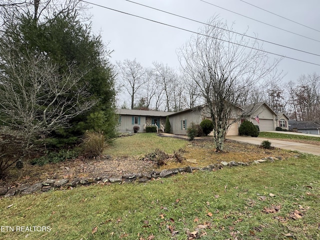 ranch-style house with a garage and a front lawn