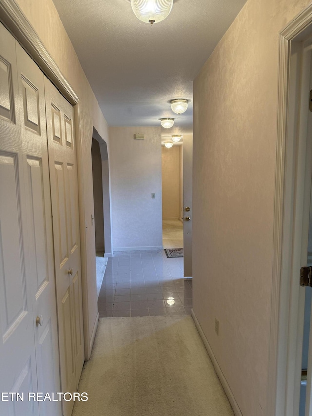 hallway featuring a textured ceiling