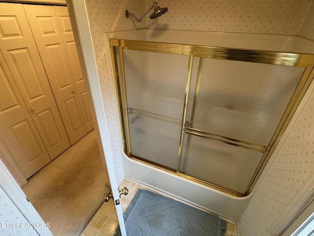 bathroom featuring shower / bath combination with glass door