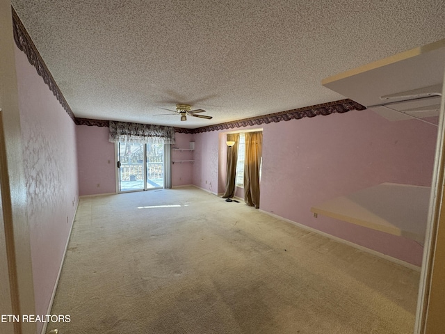 carpeted empty room featuring a textured ceiling and ceiling fan