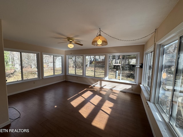 unfurnished sunroom with ceiling fan