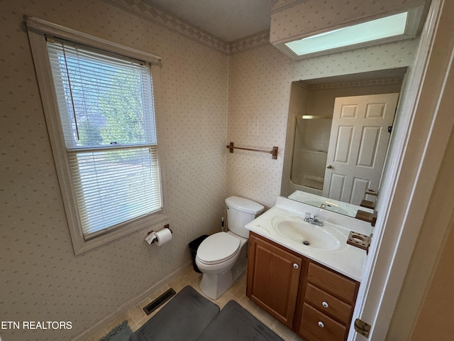 bathroom with walk in shower, tile patterned floors, toilet, and vanity