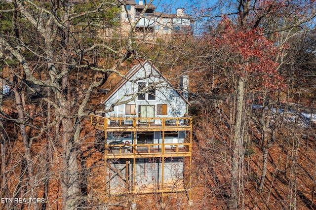 rear view of house featuring a deck