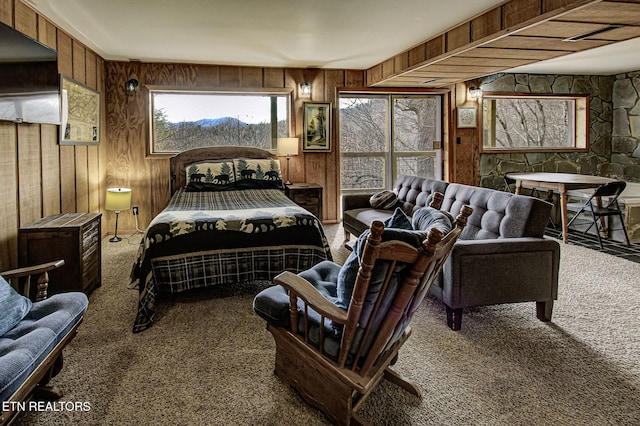 carpeted bedroom with wooden walls