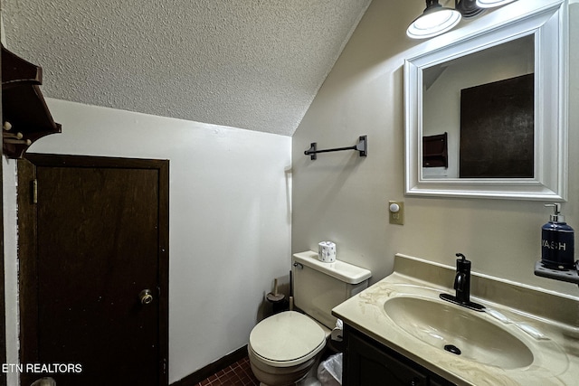 bathroom featuring tile patterned floors, a textured ceiling, lofted ceiling, toilet, and vanity