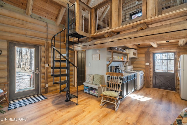 foyer with wooden ceiling, high vaulted ceiling, light wood-type flooring, rustic walls, and beam ceiling