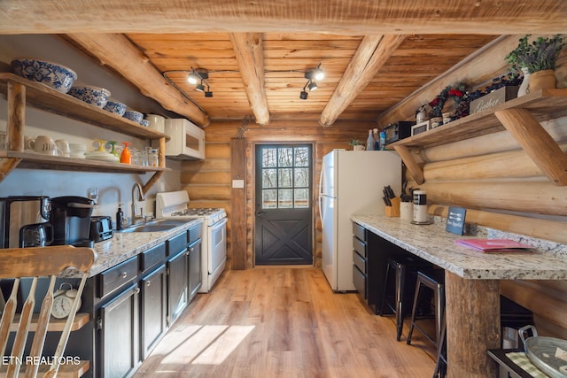 kitchen with rustic walls, wood ceiling, white appliances, beamed ceiling, and light hardwood / wood-style floors