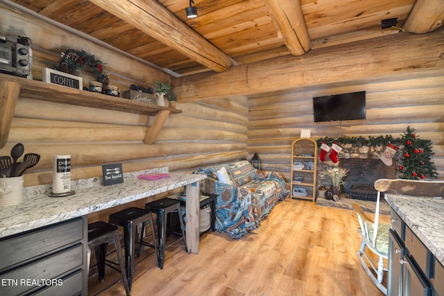 living room with beamed ceiling, light hardwood / wood-style flooring, rustic walls, and wooden ceiling