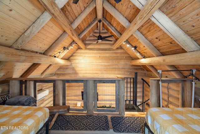 bedroom with lofted ceiling with beams, wood ceiling, and track lighting