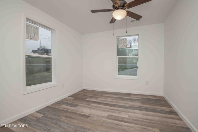 unfurnished room featuring hardwood / wood-style floors and ceiling fan