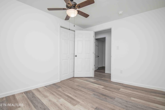 unfurnished bedroom featuring ceiling fan, a closet, and light hardwood / wood-style flooring