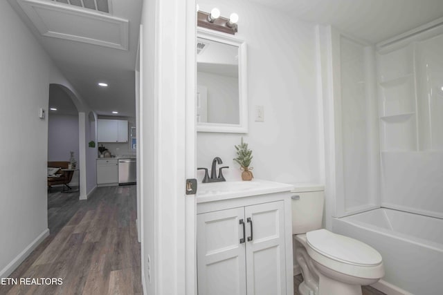 full bathroom with shower / bathing tub combination, vanity, wood-type flooring, and toilet