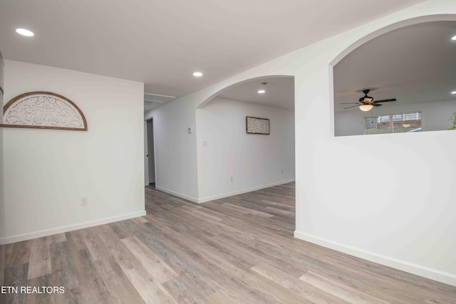 empty room featuring ceiling fan and light hardwood / wood-style flooring