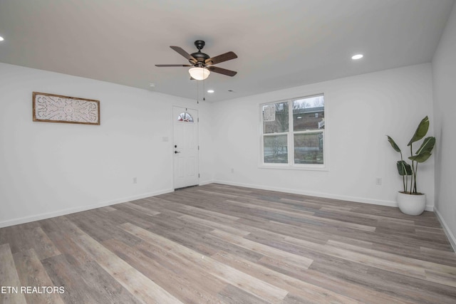 spare room with light hardwood / wood-style floors and ceiling fan