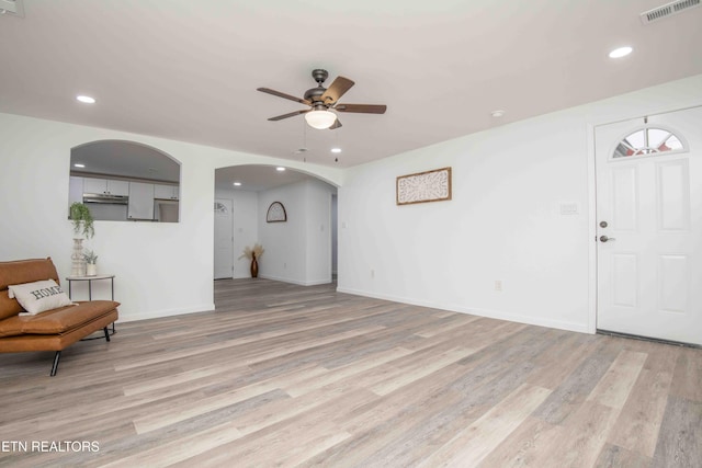 unfurnished living room with ceiling fan and light hardwood / wood-style flooring