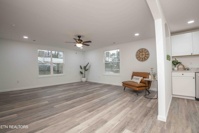 living area with ceiling fan, a healthy amount of sunlight, and light hardwood / wood-style flooring