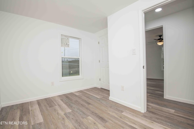 spare room with light hardwood / wood-style flooring and ceiling fan