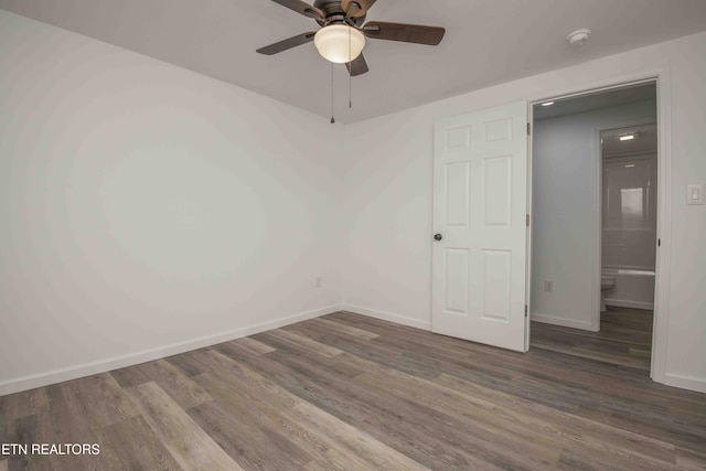 unfurnished room featuring ceiling fan and dark hardwood / wood-style flooring