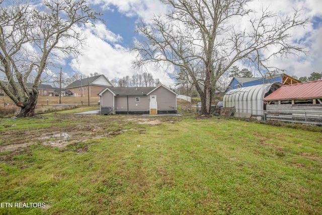 view of yard featuring an outbuilding and central air condition unit