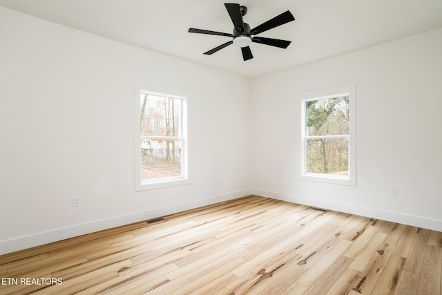 empty room with light hardwood / wood-style flooring and ceiling fan