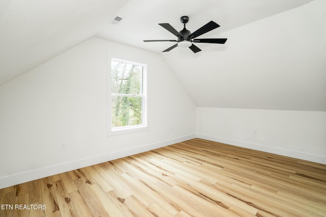 additional living space featuring hardwood / wood-style floors, vaulted ceiling, and ceiling fan