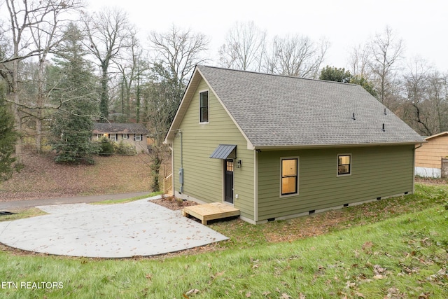 rear view of house featuring a lawn and a patio area