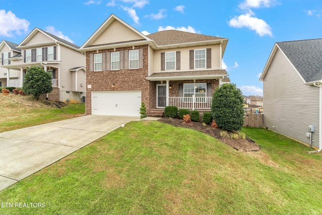 view of front of property with a porch, a garage, and a front lawn