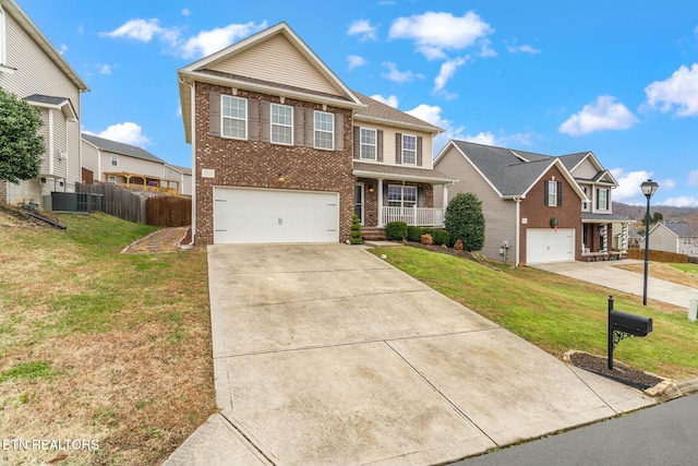 view of front of property featuring covered porch, a garage, and a front lawn