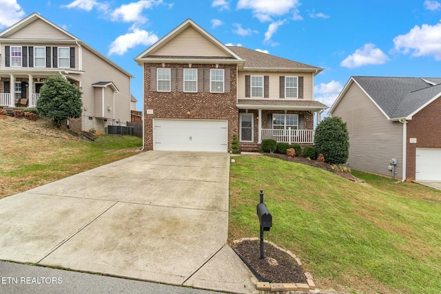 view of front of house with a porch, a garage, a front yard, and central AC