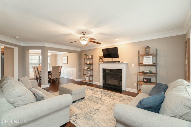 living room featuring hardwood / wood-style flooring, ceiling fan, and ornamental molding