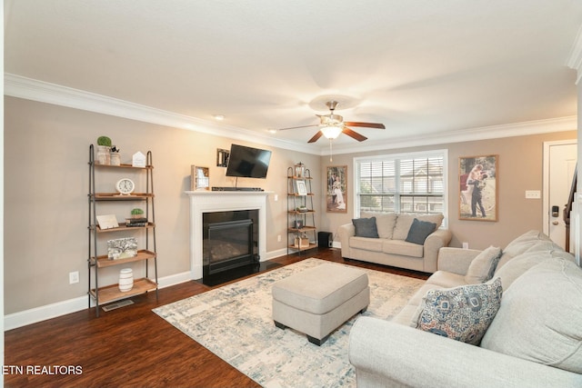 living room with crown molding, hardwood / wood-style floors, and ceiling fan