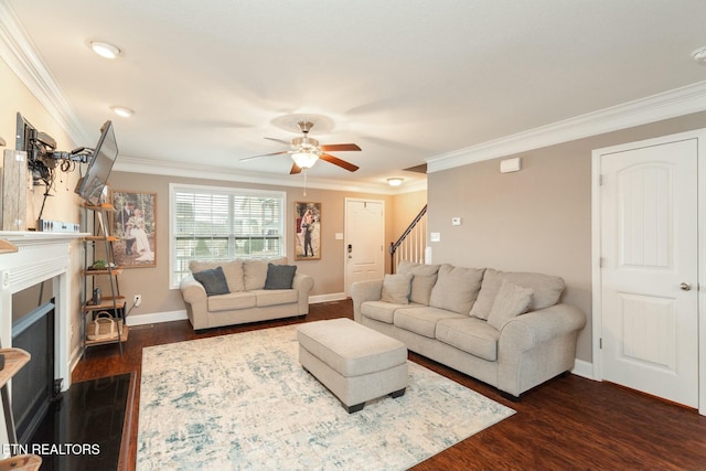 living room featuring ceiling fan, ornamental molding, and dark wood-type flooring