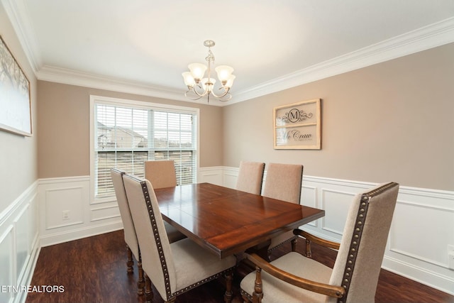 dining space with dark hardwood / wood-style flooring, an inviting chandelier, and ornamental molding