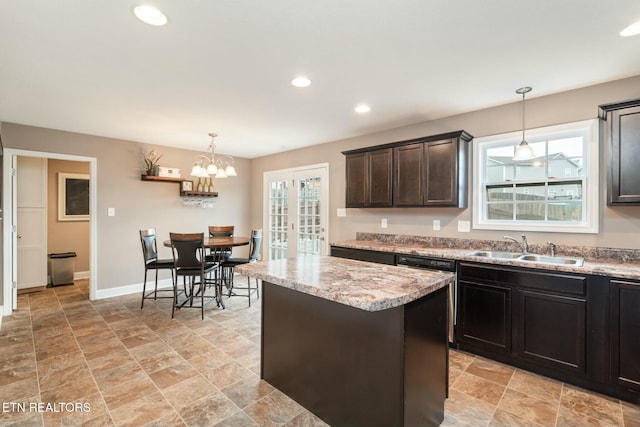 kitchen featuring decorative light fixtures, an inviting chandelier, a healthy amount of sunlight, and sink