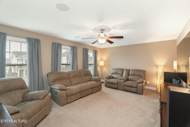 carpeted living room featuring plenty of natural light and ceiling fan