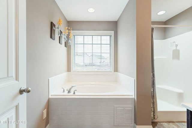 bathroom featuring vanity and independent shower and bath