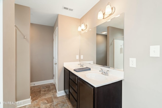 bathroom with vanity and a shower with door