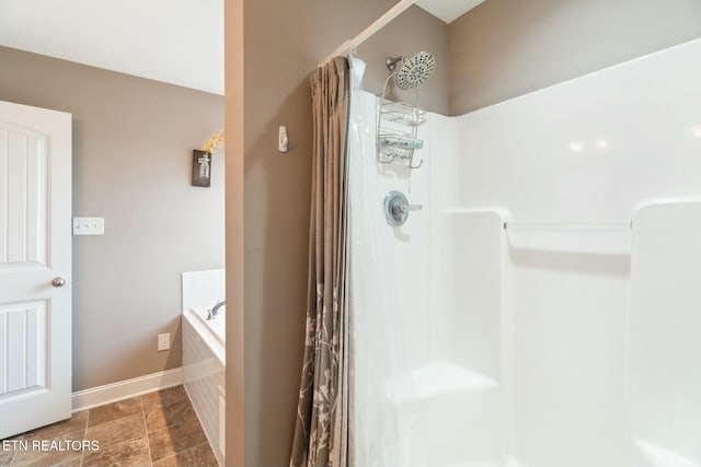 bathroom featuring shower with separate bathtub